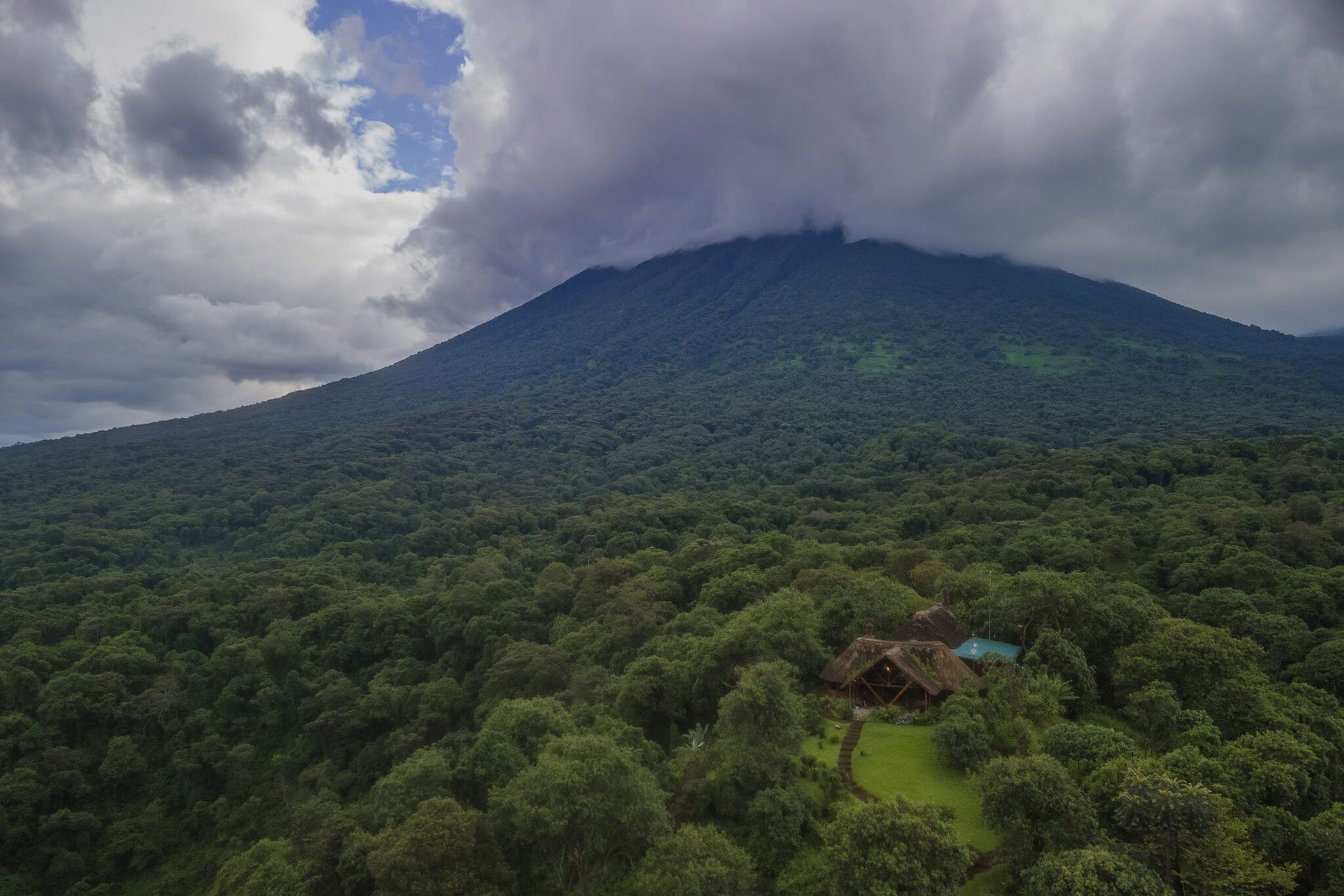Kibumba Camp lies nestled in the rainforest below Mt Mikeno